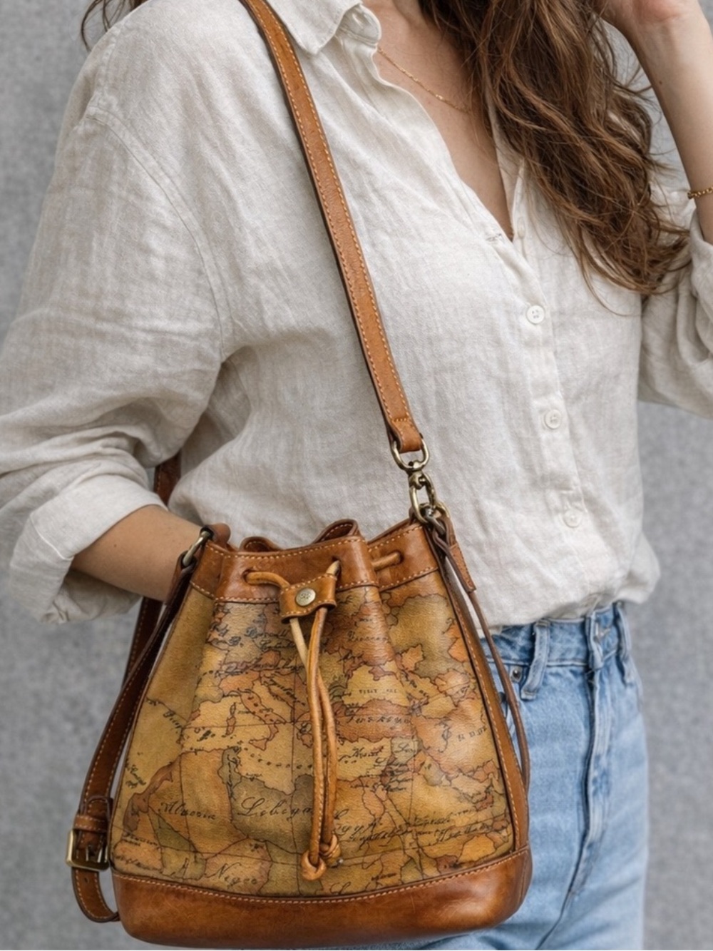 Alviero Martini tan brown Geo Map leather drawstring crossbody bag